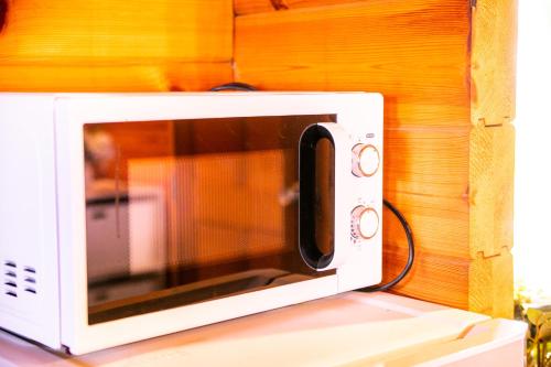 a white microwave sitting on top of a counter at Awaji Seaside Log house in Goshiki 1 in Sumoto