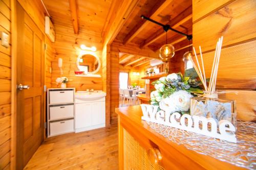a kitchen with wooden walls and wooden floors and a counter top at Awaji Seaside Log house in Goshiki 1 in Sumoto