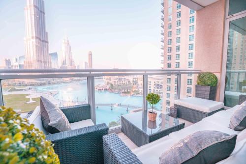 a balcony with wicker chairs and a view of the city at Elite Royal Apartment - Burj Residences Tower 5 in Dubai