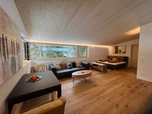 a living room with a couch and a table at River Lodge in Dornbirn