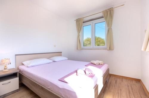 a bedroom with two beds and a window at Holiday Home Lydia in Slatine