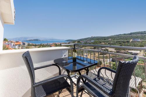 a balcony with two chairs and a table with a view at Holiday Home Lydia in Slatine