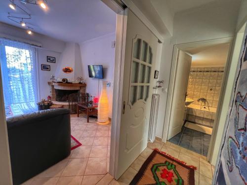 a living room with a door leading to a bathroom at "Orchomenos" Apartment of Levidi Arcadian Apartments in Levidhion