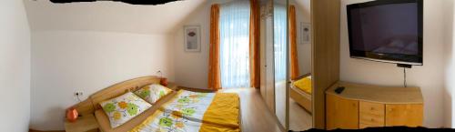 a small bedroom with a bed and a tv at Ferienwohnung Schmid in Sankt Martin am Grimming