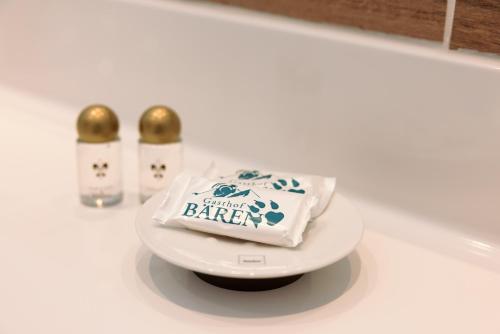 a bag of butter sitting on a plate on a counter at Gasthof Bären in Holzgau