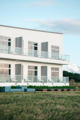 a white building with balconies on the side of it at Sunlight On the Peninsula in Eluan
