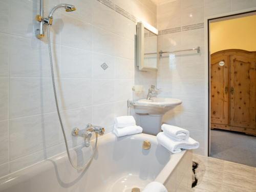 a bathroom with a shower and a sink and a tub at Appartement Dorfblick in Bad Kleinkirchheim