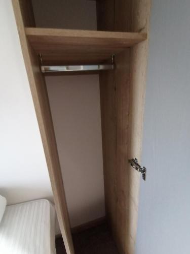 a door to a room with a bed and a closet at 69R Seawick 2 Bedroom Caravan . New for 2022 in Saint Osyth