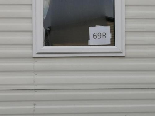 a window with a sign that says go for at 69R Seawick 2 Bedroom Caravan . New for 2022 in Saint Osyth