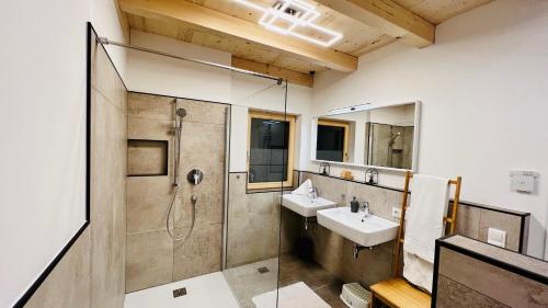 a bathroom with a shower and a sink at Mountain Inn Chalets & Apartments in Walchsee