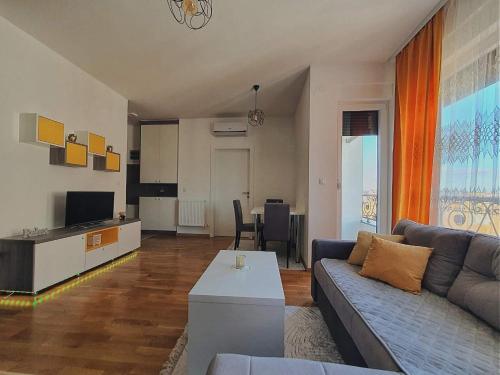 a living room with a couch and a table at Zara Apartman 1 in Bijeljina