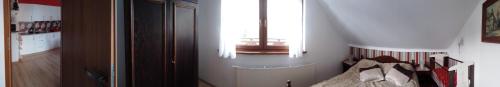 a bedroom with a window and a bed in a room at Willa Gracja in Wisła