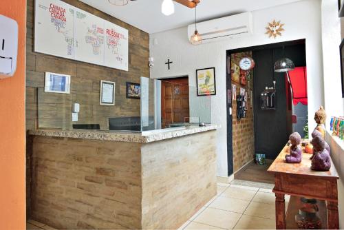 a restaurant with a counter in the middle of a room at HOTEL & HOSTEL RIBEIRAo in Ribeirão Preto