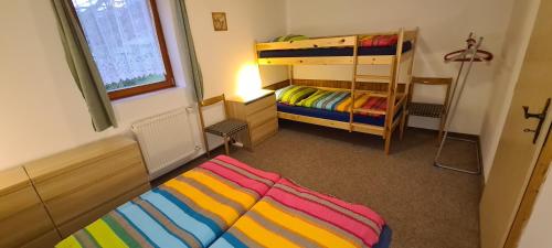 1 dormitorio con 2 literas y escalera en Apartmány Pony, en Ludvíkov