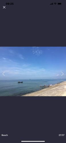 two pictures of a beach with a blue sky and the ocean at Mango Villa Long Hải Beach in Long Hai