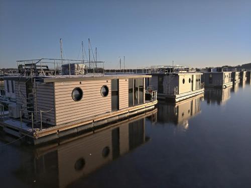 a group of boats sitting in the water at Ostsee Hausboot Schleswig Ostseeblick 1 in Schleswig