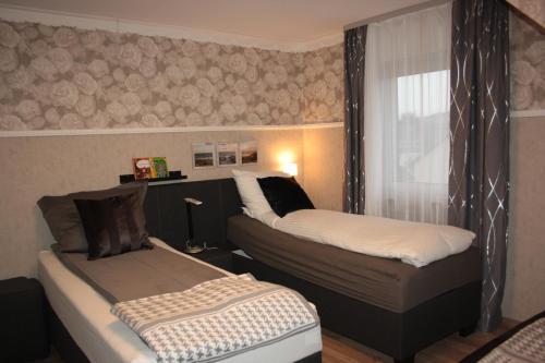 a room with two beds and a window in it at Diamanthaus 3 Koblenz in Koblenz
