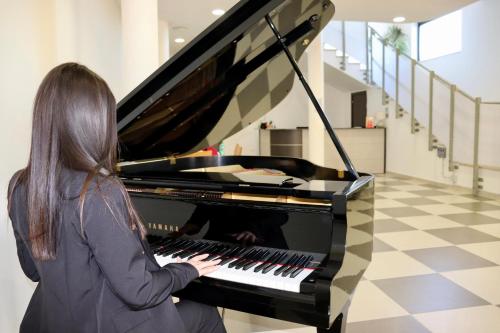 a woman playing a piano in a hallway at L'incontro in Trinitapoli