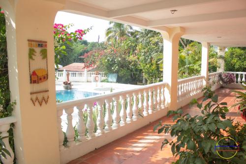 a balcony with a view of a swimming pool at Hotel Finca Londres in Villeta