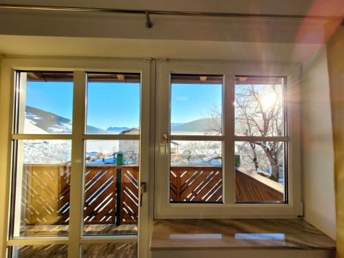 a window with views of the snow covered mountains at Ferienwohnung Flachau Oberlehengut in Flachau