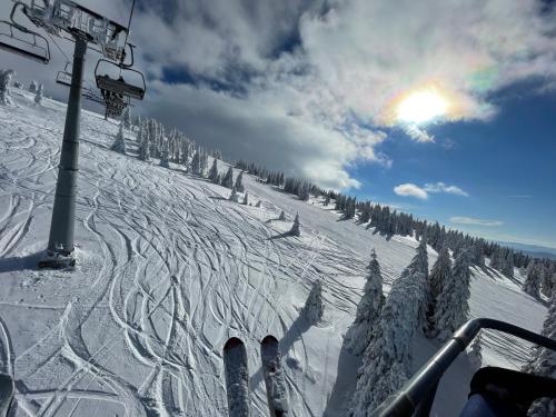 a snow covered ski slope with a ski lift at Pano Kopaonik Panorama in Kopaonik