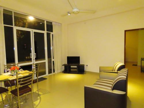 a living room with a couch and a table at VIVAS Residencies Luxury Apartments in Colombo