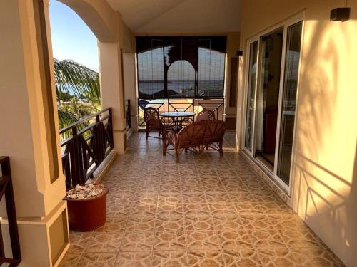 a balcony with a table and chairs on a balcony at Villa Palmistes Apartment in La Gaulette