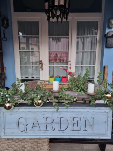 a sign that says garden on a table with plants at VILLA VILLACOLLE in Procchio