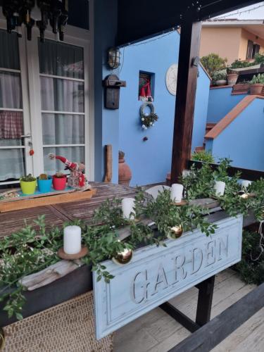 a garden sign on the front porch of a house at VILLA VILLACOLLE in Procchio