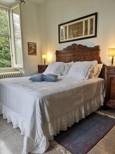 a bed with two pillows on it in a bedroom at Villa Monacelli in Fano
