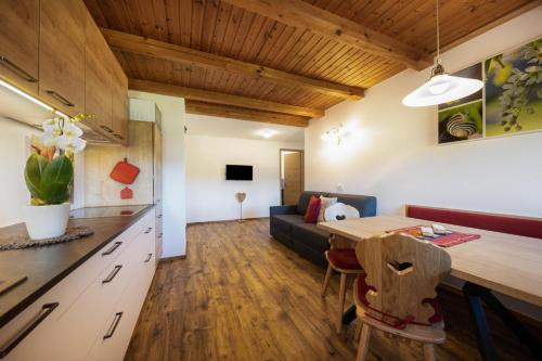 a kitchen and living room with a table and a couch at Gfliererhof in Fiè