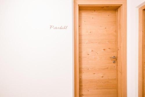 a wooden door in a white room at Gfliererhof in Fiè