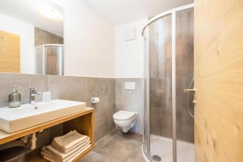 a bathroom with a sink toilet and a shower at Gfliererhof in Fiè