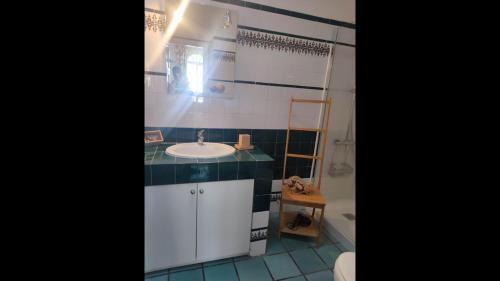 a bathroom with a white sink and a shower at First Line Luxury Apartment by El Sirocco in Puerto de Mogán