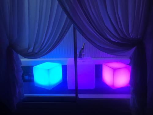 a room with a window with purple and blue lights at Suite Vitbanus in Marbella