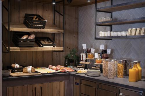 a kitchen with a counter with food on it at Alpendorf Hotel Stern in Sankt Johann im Pongau