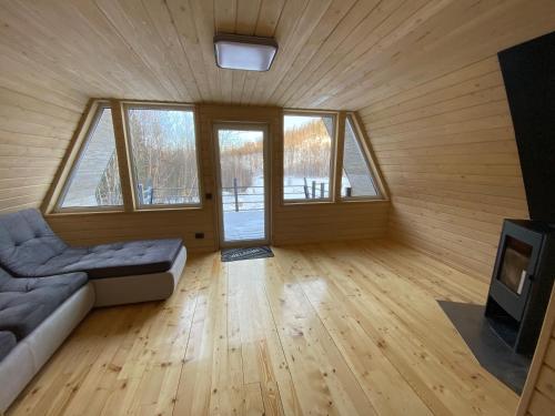 a living room with a couch and a tv and windows at Soul House in Bagna