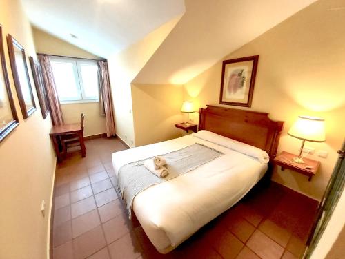 a bedroom with a bed with a teddy bear on it at Plaza Andalucía Edificio Dornajo 2-4 pax in Monachil