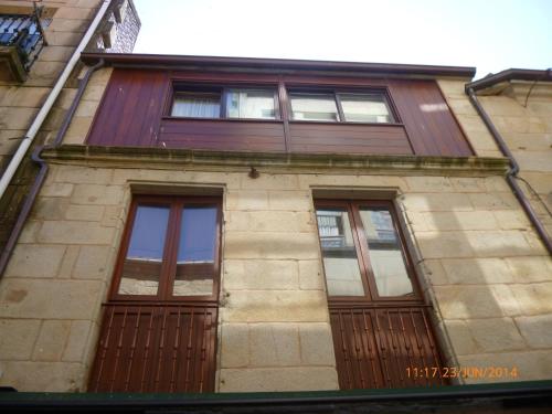 a building with wooden doors and windows on it at Hotel Boa Vila in Pontevedra