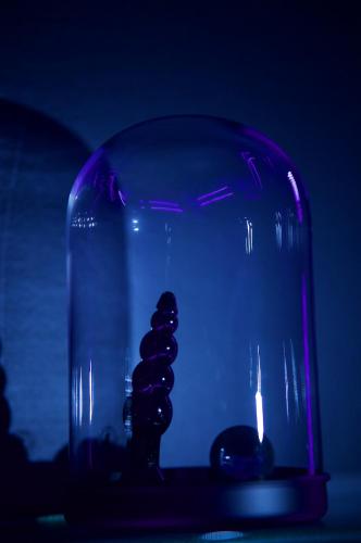 a glass vase with a bunch of rocks in it at PARENTHESE LOVE - Amour & Tentation Suite Balnéo SPA Proche Orly-Paris in La Ville-du-Bois