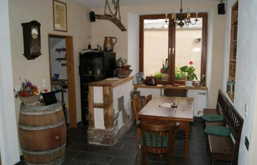 a kitchen with a table and a room with a fireplace at Weingut Gästehaus Bach in Cochem