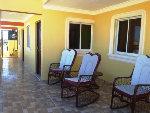 a group of chairs sitting on a porch at Serviced 1 Bedroom Apartment in Corales del Sur in La Viva