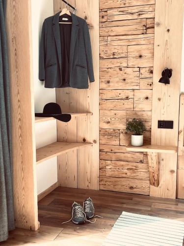 a room with a coat hanging on a wooden wall at Pension Kreuzeck - Dein Glücksplatz am Lech in Weissenbach am Lech