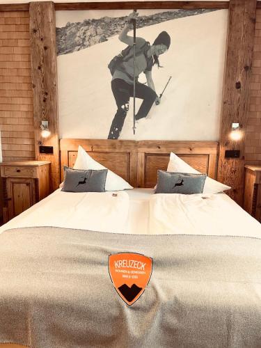 a hotel room with a bed with a sign on it at Pension Kreuzeck - Dein Glücksplatz am Lech in Weissenbach am Lech