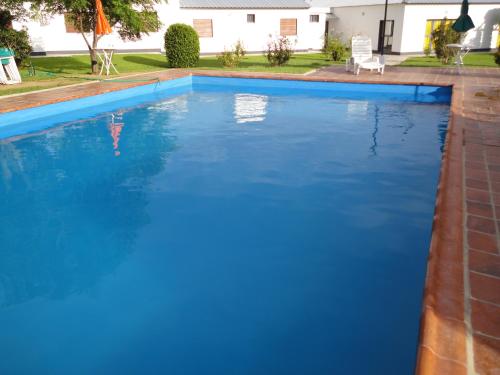 a large swimming pool with blue water at Hotel Lujan in Luján