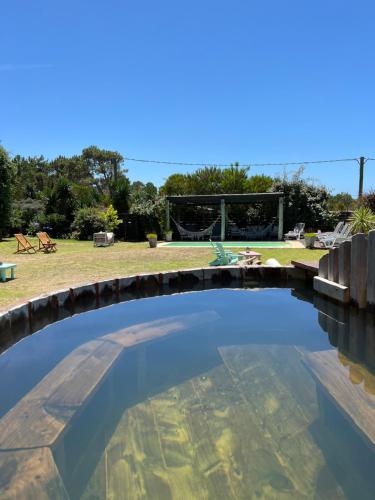a large swimming pool in a yard at Los Pecados de la Viuda in Punta Del Diablo