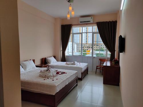 מיטה או מיטות בחדר ב-Thanh Nien Hotel - Vung Tau