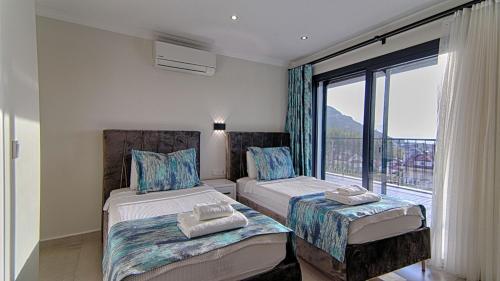 A bed or beds in a room at KAAN VILLA