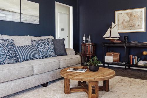 a living room with a couch and a coffee table at Mountford Cottage in Metung