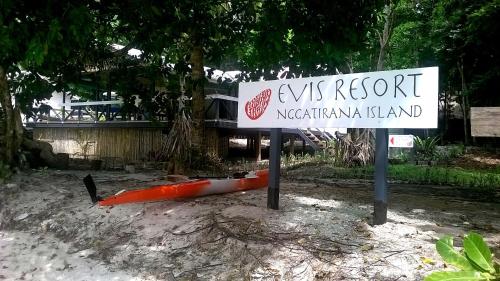 a sign for a resort with a kayak next to it at Evis Resort at Nggatirana Island in Halisi